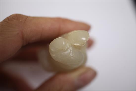 A Chinese white jade figure of a boy holding a bird, 18th/19th century, 6.2cm